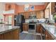 Cozy eat-in kitchen featuring stainless appliances, wood cabinets, granite counters and a colorful rug on the floor at 461 Spauldingwood Rd., Little River, SC 29566