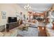 An open-concept living room and kitchen area with tile flooring, comfortable seating, and stylish furnishings at 461 Spauldingwood Rd., Little River, SC 29566