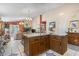 Open concept living room with kitchen island, brick fireplace, tile flooring, and dining room table at 461 Spauldingwood Rd., Little River, SC 29566