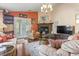 A warm and inviting living room featuring a brick fireplace, hardwood flooring, and ample natural light at 461 Spauldingwood Rd., Little River, SC 29566