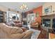 Spacious living room features a brick fireplace, hardwood floors, and comfortable seating for the whole Gathering at 461 Spauldingwood Rd., Little River, SC 29566