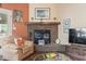 Cozy living room features a brick fireplace with mantel and comfortable seating at 461 Spauldingwood Rd., Little River, SC 29566
