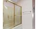Shower stall with gold trim and patterned glass sliding door at 461 Spauldingwood Rd., Little River, SC 29566