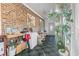 Bright sun room with exposed brick, tile floors, and a cozy seating area at 461 Spauldingwood Rd., Little River, SC 29566