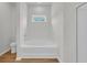 This bathroom features a soaking tub with a window above and a tiled floor at 4745 Huckleberry Ln., Conway, SC 29526