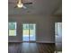 Bright and airy living room with sliding glass doors leading to a backyard at 4745 Huckleberry Ln., Conway, SC 29526