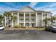 Exterior view of a three-story condo building with palm trees at 5090 Windsor Green Way # 104, Myrtle Beach, SC 29579