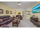 Spacious living room with leather furniture and view into kitchen at 5090 Windsor Green Way # 104, Myrtle Beach, SC 29579