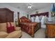 Large bedroom with a king-size bed and ornate wooden frame at 5090 Windsor Green Way # 104, Myrtle Beach, SC 29579