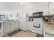 Galley kitchen with white cabinets and appliances at 5601 North Ocean Blvd. # B-312, Myrtle Beach, SC 29577