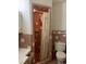 Cozy bathroom featuring pink tile, shower with curtain, and toilet at 5944 Rose Hill Rd., Georgetown, SC 29440