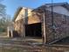 View of brick house showing attached open garage and stairs leading to backyard at 5944 Rose Hill Rd., Georgetown, SC 29440