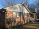 Brick house featuring white trim, double windows and mature landscaping at 5944 Rose Hill Rd., Georgetown, SC 29440