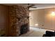 A cozy room with paneled walls, brick fireplace and ceiling fan at 5944 Rose Hill Rd., Georgetown, SC 29440