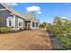 The house and lot feature mature landscaping with a variety of trees and shrubs at 5960 Bolsena Place, Myrtle Beach, SC 29577