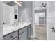 Gray vanity with marble countertop inside of the bathroom and entry into bedroom at 5960 Bolsena Place, Myrtle Beach, SC 29577