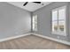 Bedroom featuring two windows and neutral carpet and gray paint at 5960 Bolsena Place, Myrtle Beach, SC 29577