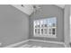 Bright bedroom with large window, plantation shutters, vaulted ceiling and a modern chandelier at 5960 Bolsena Place, Myrtle Beach, SC 29577
