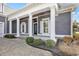 A spacious porch with stately columns enhances this home's curb appeal at 5960 Bolsena Place, Myrtle Beach, SC 29577