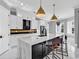 Elegant kitchen with white cabinets, a large island with marble countertop, and stylish pendant lighting at 5960 Bolsena Place, Myrtle Beach, SC 29577