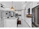 Large kitchen featuring a marble island, gas range and oven and a view to the entry and living room at 5960 Bolsena Place, Myrtle Beach, SC 29577