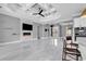Spacious living room with a coffered ceiling, modern fireplace, and views into the kitchen and dining area at 5960 Bolsena Place, Myrtle Beach, SC 29577