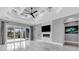 A modern room features a tray ceiling, fireplace, tile floors and an open concept at 5960 Bolsena Place, Myrtle Beach, SC 29577