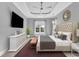 Large bedroom with a ceiling fan, tray ceiling and a view to the backyard at 5960 Bolsena Place, Myrtle Beach, SC 29577