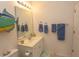 Clean bathroom with a single sink vanity, shower, and decorative fish art at 601 N Hillside Dr. # 3634, North Myrtle Beach, SC 29582