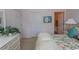 Bedroom with floral bedding, window, and white furniture at 601 N Hillside Dr. # 3634, North Myrtle Beach, SC 29582