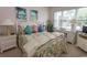 Bedroom with floral bedding, window, and white furniture at 601 N Hillside Dr. # 3634, North Myrtle Beach, SC 29582