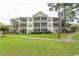 Three-story building with screened porches and lush landscaping at 601 N Hillside Dr. # 3634, North Myrtle Beach, SC 29582