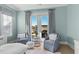 Serene bedroom with two armchairs and direct access to a private patio at 6025 Bolsena Place, Myrtle Beach, SC 29577