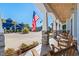 Inviting front porch with rocking chairs and American flag at 6025 Bolsena Place, Myrtle Beach, SC 29577