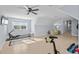 Large home gym with various exercise equipment and natural light at 6025 Bolsena Place, Myrtle Beach, SC 29577