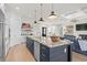 Modern kitchen features a large island with granite countertops and stainless steel appliances at 6025 Bolsena Place, Myrtle Beach, SC 29577