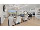 Open living space with a stone fireplace, large windows, and kitchen views at 6025 Bolsena Place, Myrtle Beach, SC 29577