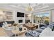 Spacious living room with a fireplace, large windows and comfortable seating at 6025 Bolsena Place, Myrtle Beach, SC 29577