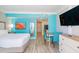 Bright condo bedroom and dining area with beach-themed decor, a flat screen TV, and a kitchenette at 7200 N Ocean Blvd. # 314, Myrtle Beach, SC 29572