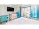 Condo bedroom with stylish furniture, a flat screen TV, beach-themed accents, and balcony access at 7200 N Ocean Blvd. # 314, Myrtle Beach, SC 29572
