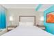 Well-lit condo bedroom with a large bed, stylish bedside tables, and a beach-themed accent wall at 7200 N Ocean Blvd. # 314, Myrtle Beach, SC 29572