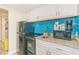 A well-organized kitchenette features modern appliances and a stylish blue tile backsplash at 7200 N Ocean Blvd. # 314, Myrtle Beach, SC 29572