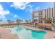 Inviting outdoor pool area with lounge chairs, beach views, and tropical landscaping at 7200 N Ocean Blvd. # 314, Myrtle Beach, SC 29572