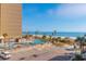 An elevated view of the condo complex pool, palm trees, beach access, and parking at 7200 N Ocean Blvd. # 314, Myrtle Beach, SC 29572
