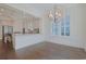 Bright dining room features hardwood floors, a chandelier, and an open kitchen view at 822 Farrow Pkwy., Myrtle Beach, SC 29577