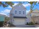 Light gray two-story house with a white double garage door and landscaping at 822 Farrow Pkwy., Myrtle Beach, SC 29577