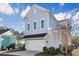 Two-story house with light gray siding, white garage door, and landscaping at 822 Farrow Pkwy., Myrtle Beach, SC 29577