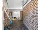 Unfinished garage with exposed brick walls and a staircase at 9095 Highway 701 South, Conway, SC 29527