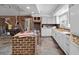 Unfinished kitchen with white cabinets and brick walls at 9095 Highway 701 South, Conway, SC 29527