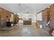 Open kitchen and living space with exposed brick and concrete floors at 9095 Highway 701 South, Conway, SC 29527